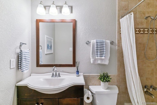 6650 E Arizona Ave Unit 154, Denver, CO 80224 - full bath featuring toilet, a textured wall, tiled shower, and vanity