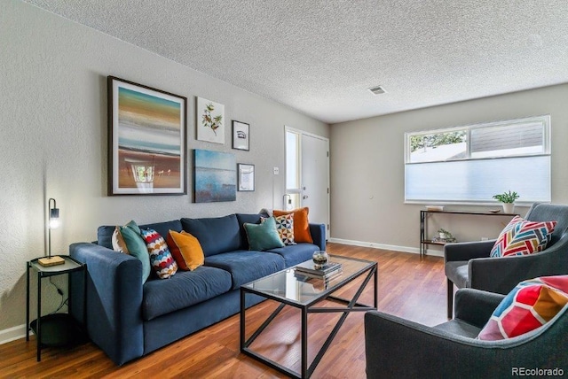 6650 E Arizona Ave Unit 154, Denver, CO 80224 - living area featuring wood finished floors, a textured ceiling, and a textured wall