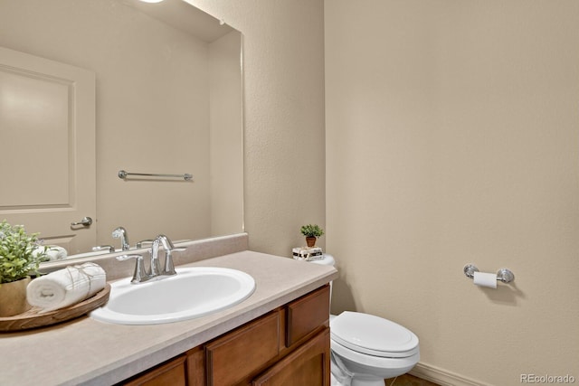 half bath with vanity and toilet