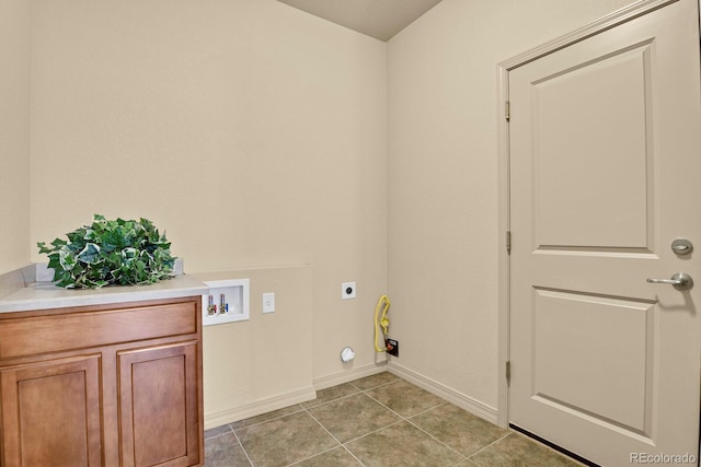 clothes washing area with light tile patterned floors, hookup for a washing machine, baseboards, cabinet space, and electric dryer hookup