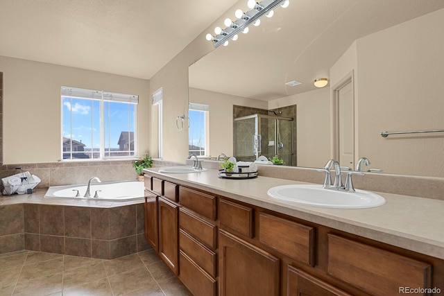 full bathroom with a garden tub, tile patterned flooring, a sink, and a shower stall