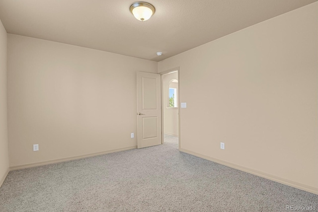 spare room with carpet flooring and baseboards