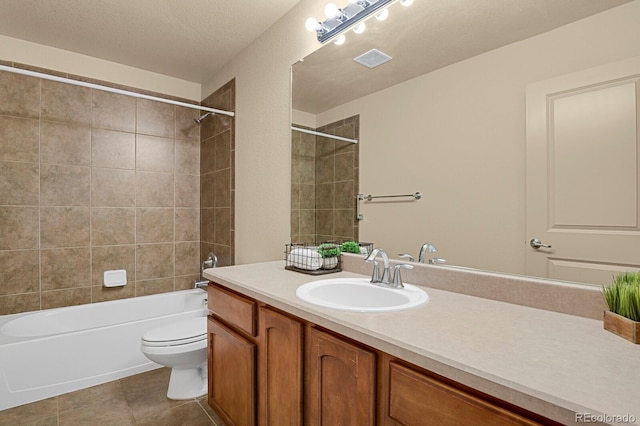 bathroom with visible vents, toilet, vanity,  shower combination, and tile patterned flooring