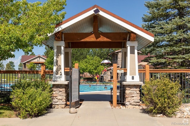 pool featuring fence and a gazebo