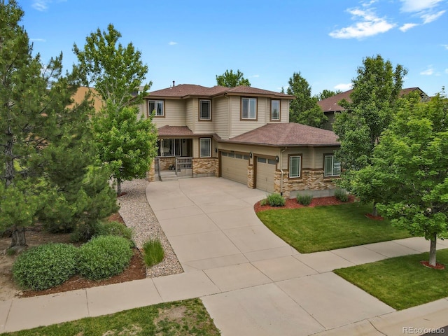 24269 E Arapahoe Pl, Aurora, CO 80016 - prairie-style house with concrete driveway, a front yard, an attached garage, a porch, and stone siding