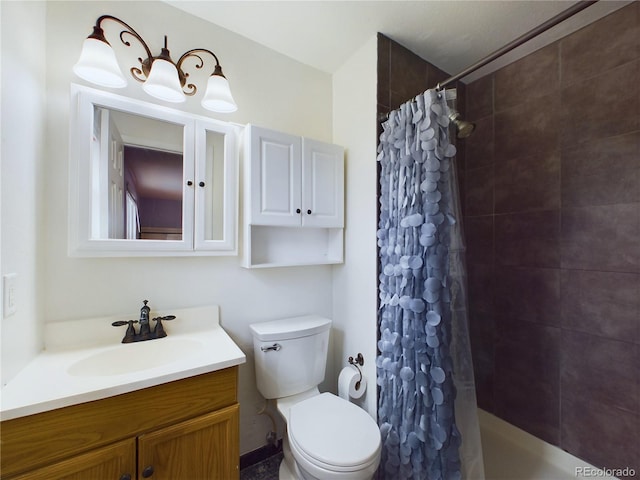 bathroom featuring a tile shower, vanity, and toilet