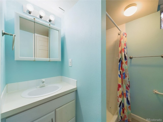 full bath featuring a stall shower and vanity