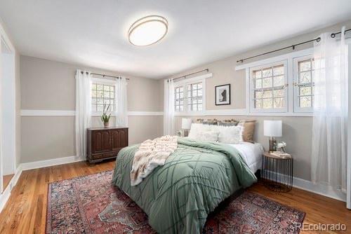 bedroom with baseboards and wood finished floors