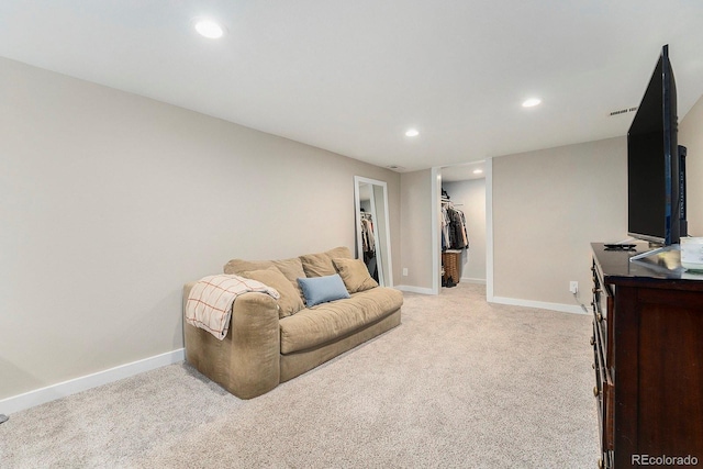 living room featuring baseboards, recessed lighting, and light colored carpet