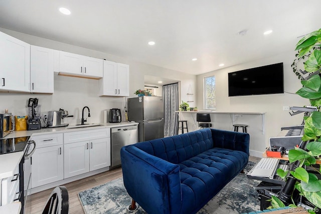 living room featuring recessed lighting and light wood finished floors