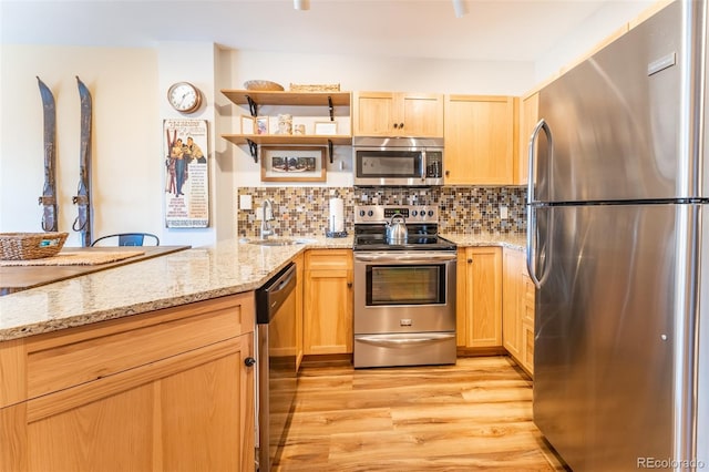 150 Dercum Sq Unit 8501, Keystone, CO 80435 - kitchen featuring light wood finished floors, a sink, tasteful backsplash, and appliances with stainless steel finishes
