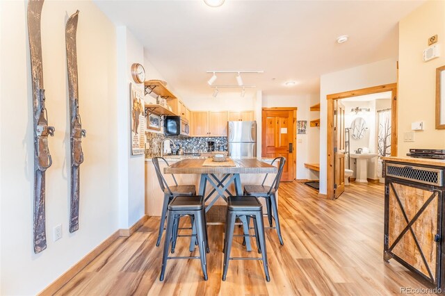 150 Dercum Sq Unit 8501, Keystone, CO 80435 - dining room with baseboards, visible vents, light wood-style floors, and track lighting
