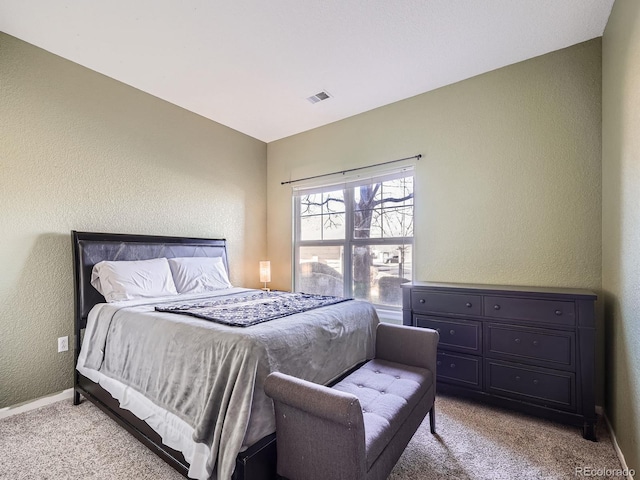 bedroom with light colored carpet and lofted ceiling