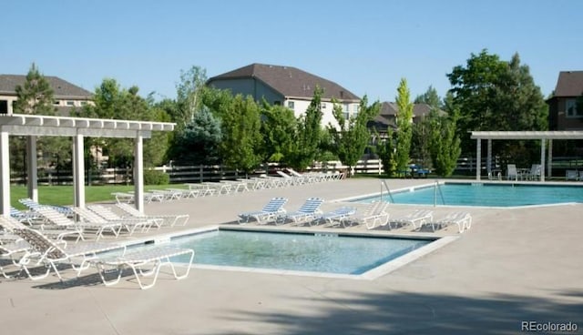 view of pool with a pergola and a patio area