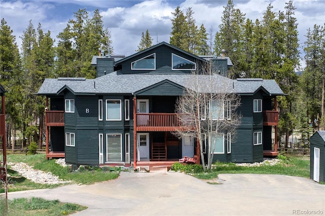 753 County Road 830 Unit 1, Fraser, CO 80442 - view of property with a balcony, a shingled roof, and a chimney