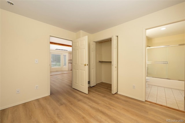 753 County Road 830 Unit 1, Fraser, CO 80442 - unfurnished bedroom with light wood finished floors, baseboards, and connected bathroom