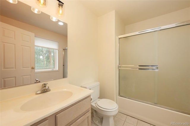 753 County Road 830 Unit 1, Fraser, CO 80442 - full bath featuring tile patterned flooring, toilet, vanity, and combined bath / shower with glass door