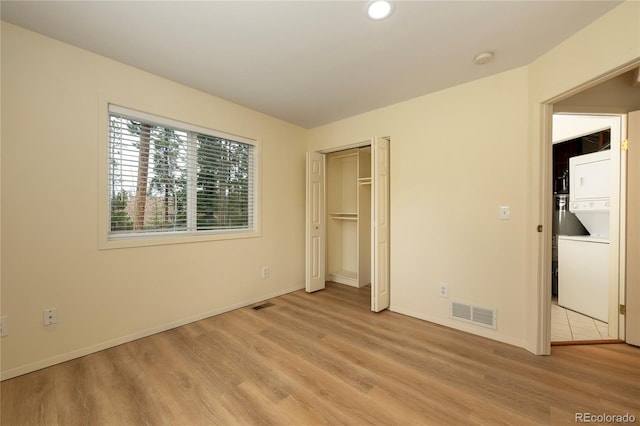 753 County Road 830 Unit 1, Fraser, CO 80442 - unfurnished bedroom featuring stacked washer / drying machine, light wood-type flooring, baseboards, and recessed lighting