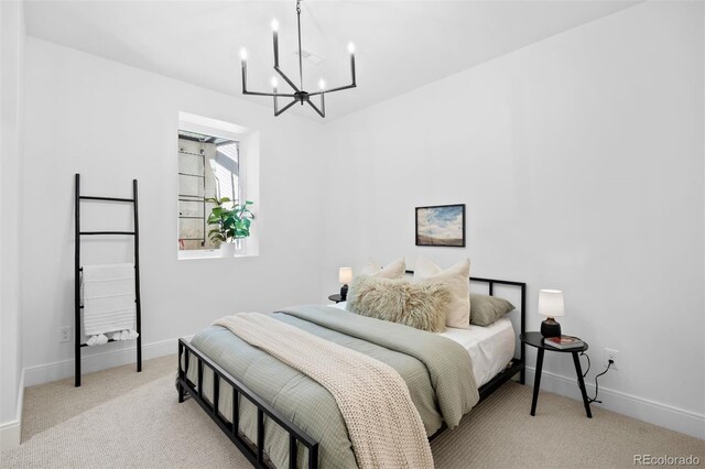 carpeted bedroom with a chandelier