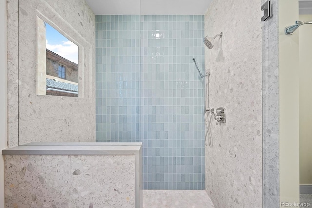 bathroom with tiled shower