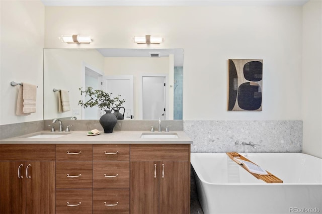 bathroom with vanity and a tub