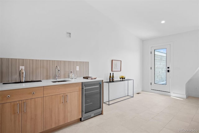 kitchen with lofted ceiling, sink, and wine cooler