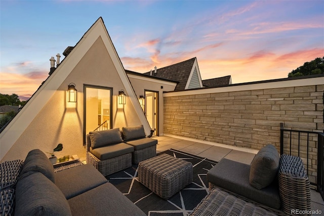 patio terrace at dusk featuring an outdoor hangout area