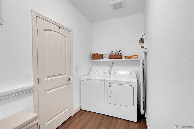 washroom with washing machine and dryer and dark hardwood / wood-style floors