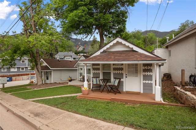 517 Canon Ave, Manitou Springs, CO 80829 - view of front facade with a mountain view, roof with shingles, and a porch