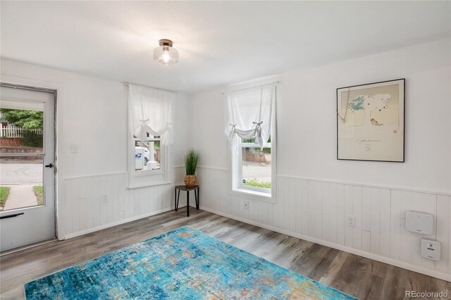 517 Canon Ave, Manitou Springs, CO 80829 - unfurnished room featuring wood finished floors, wainscoting, and wooden walls