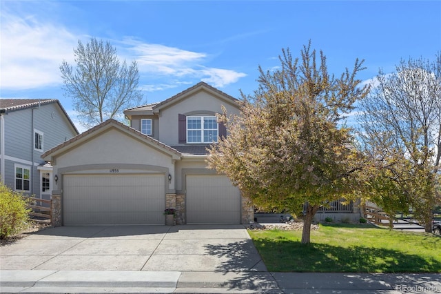 view of front of home featuring a tiled roof, stucco siding, concrete driveway, stone siding, and a front lawn