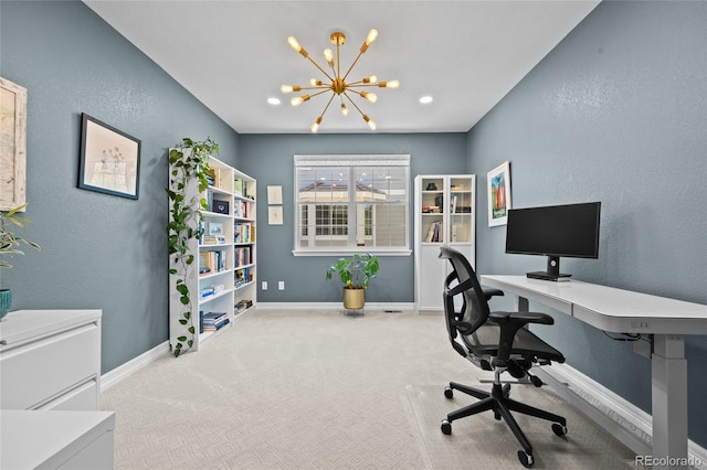 carpeted office with an inviting chandelier, baseboards, and a textured wall