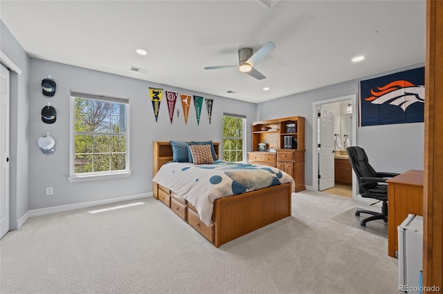 bedroom with light colored carpet, multiple windows, baseboards, and recessed lighting