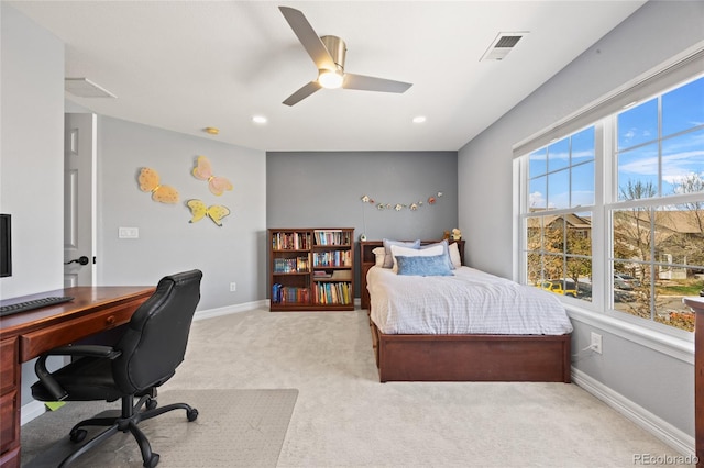 bedroom featuring light colored carpet, visible vents, baseboards, and a ceiling fan