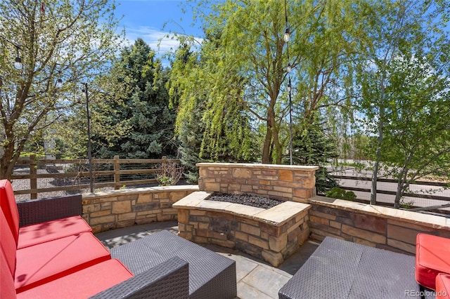 view of patio with a fire pit and fence