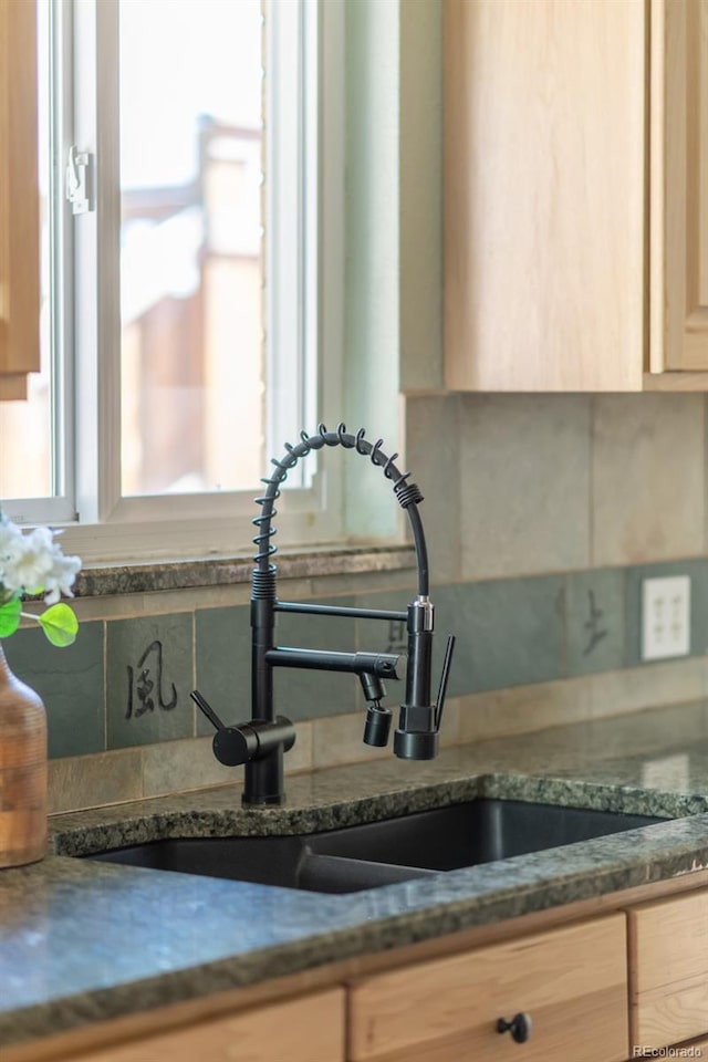 kitchen view of backsplash and a sink