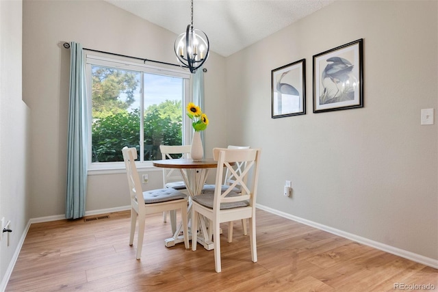 7 Shetland Ct, Highlands Ranch, CO 80130 - dining area featuring a chandelier, light wood-style floors, baseboards, and vaulted ceiling