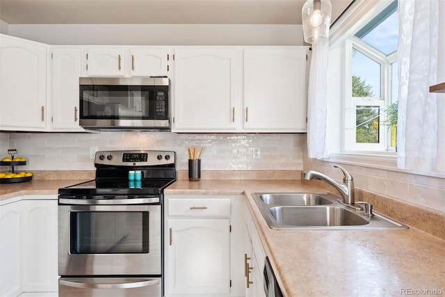 7 Shetland Ct, Highlands Ranch, CO 80130 - kitchen featuring appliances with stainless steel finishes, a sink, white cabinetry, and healthy amount of natural light