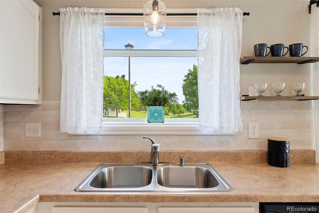 7 Shetland Ct, Highlands Ranch, CO 80130 - kitchen featuring a sink, dishwasher, white cabinetry, and light countertops