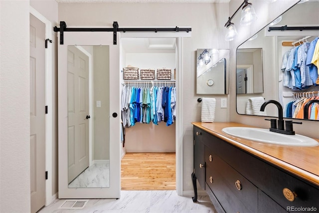 7 Shetland Ct, Highlands Ranch, CO 80130 - bathroom with vanity, marble finish floors, and a spacious closet