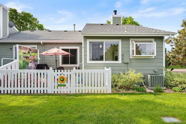 7 Shetland Ct, Highlands Ranch, CO 80130 - rear view of house featuring central air condition unit and a chimney