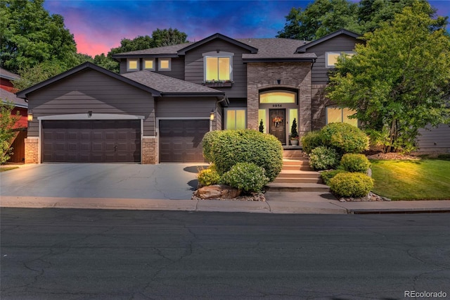 9856 Glenstone Trl, Highlands Ranch, CO 80130 - view of front facade with brick siding, an attached garage, driveway, and roof with shingles