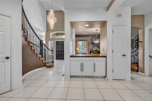 9856 Glenstone Trl, Highlands Ranch, CO 80130 - foyer entrance featuring a chandelier, stairs, and light tile patterned floors
