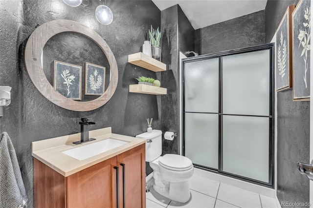 9856 Glenstone Trl, Highlands Ranch, CO 80130 - bathroom featuring a textured wall, vanity, a stall shower, and tile patterned flooring