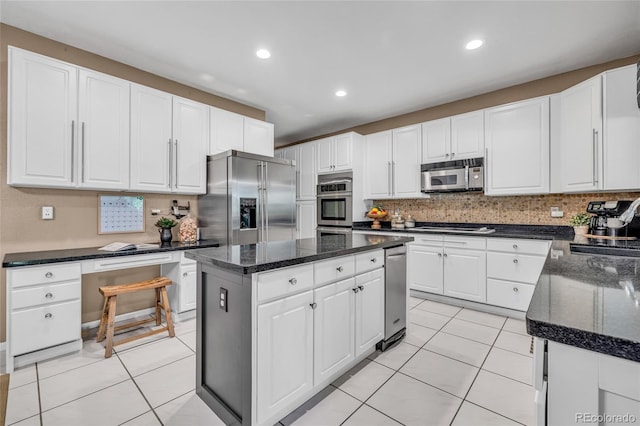 9856 Glenstone Trl, Highlands Ranch, CO 80130 - kitchen with stainless steel appliances, a center island, white cabinetry, tasteful backsplash, and recessed lighting