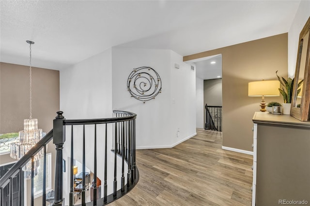 9856 Glenstone Trl, Highlands Ranch, CO 80130 - hall with an upstairs landing, a chandelier, wood finished floors, and recessed lighting