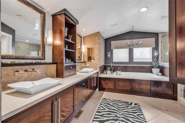 9856 Glenstone Trl, Highlands Ranch, CO 80130 - bathroom with vaulted ceiling, tile patterned flooring, a bath, double vanity, and a chandelier