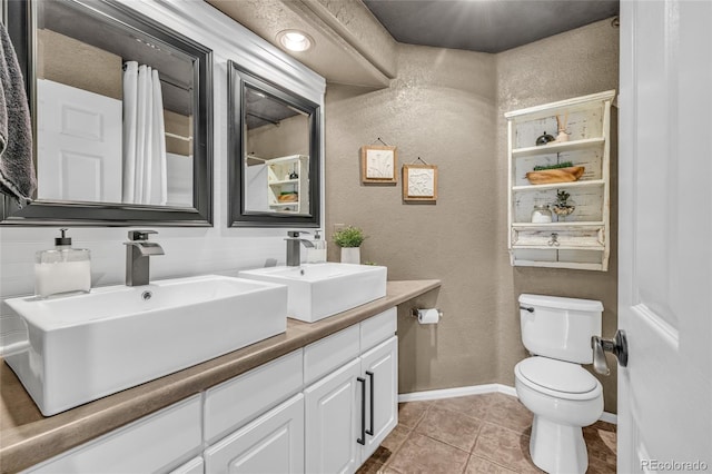 9856 Glenstone Trl, Highlands Ranch, CO 80130 - bathroom with a textured wall, double vanity, and tile patterned floors