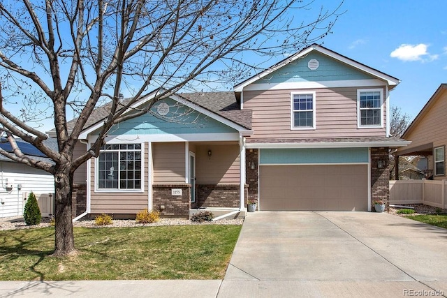 1275 W 50th St, Loveland, CO 80538 - view of front of house with brick siding, concrete driveway, and a garage