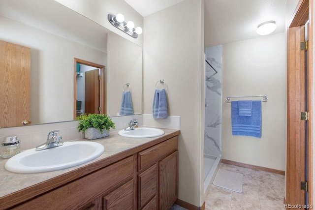 1275 W 50th St, Loveland, CO 80538 - full bathroom with a shower stall, double vanity, and baseboards